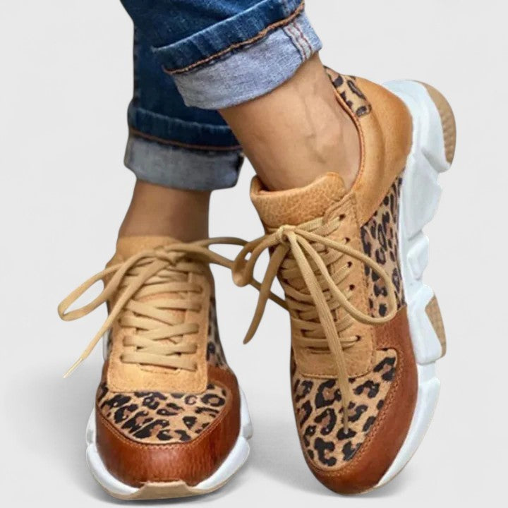 front view of leopard-print sneakers with lace-up tan laces and white sole