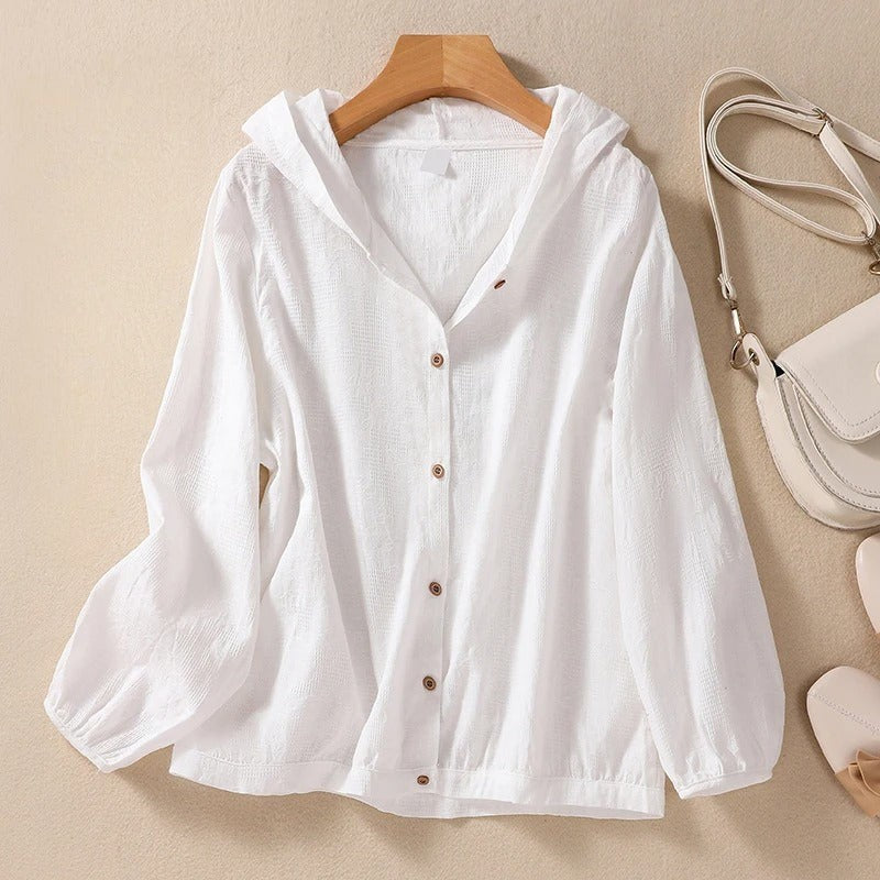 white hooded button-down shirt with long sleeves on wooden hanger