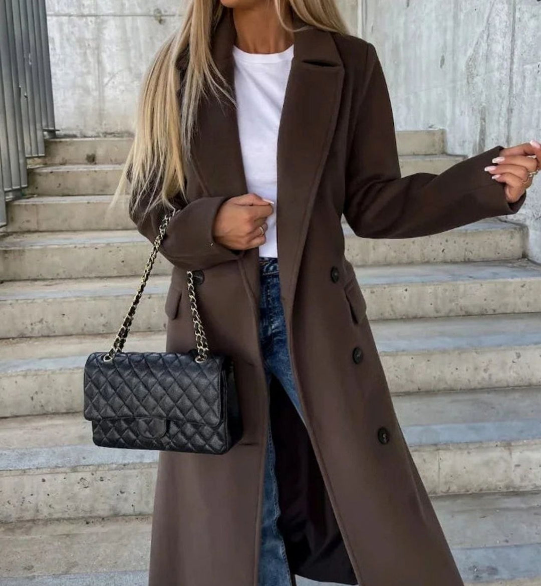Dark brown double-breasted longline coat worn with tailored lapel collar