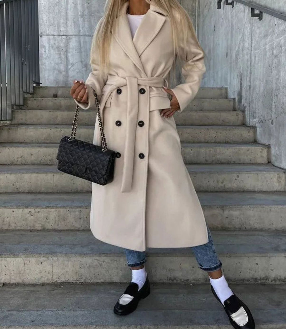 Cream belted double-breasted wool coat styled with jeans and loafers