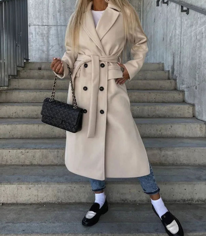 Cream belted double-breasted wool coat styled with jeans and loafers