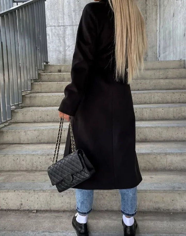 Black longline wool coat shown from behind with belted waist detail