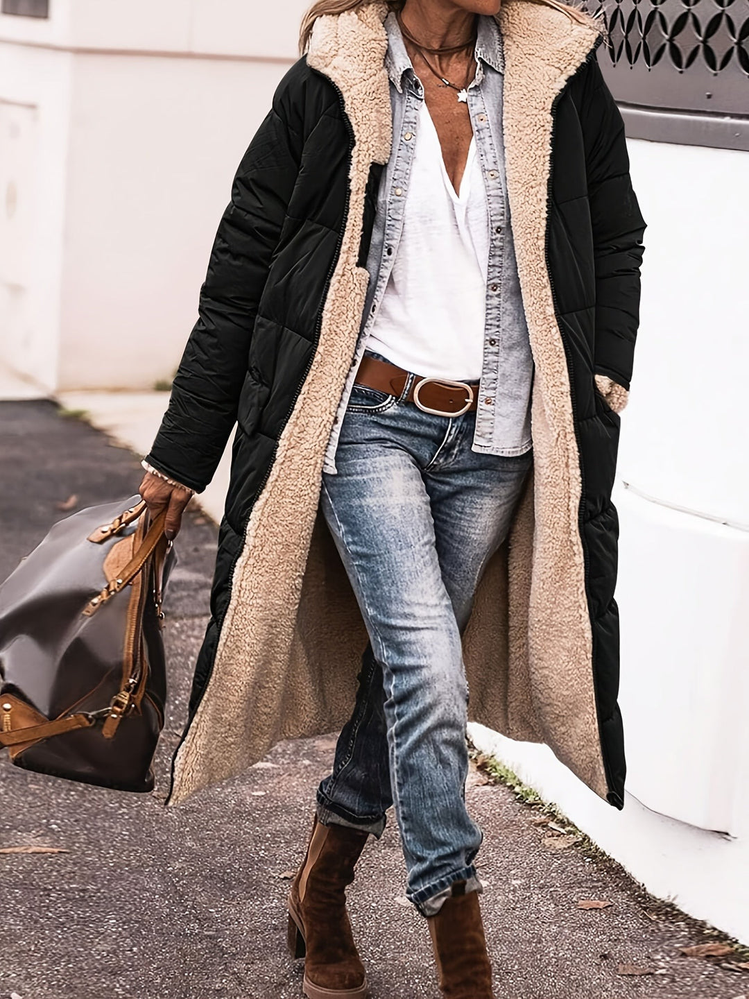 Black longline puffer coat featuring plush cream sherpa lining and hood