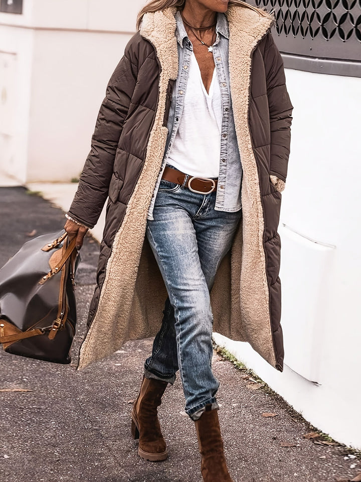 Dark brown long puffer coat with sherpa lining styled with jeans and boots