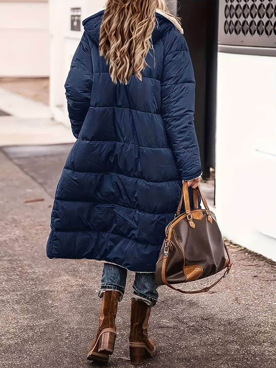 Back view of navy blue maxi puffer coat with hood and quilted panels