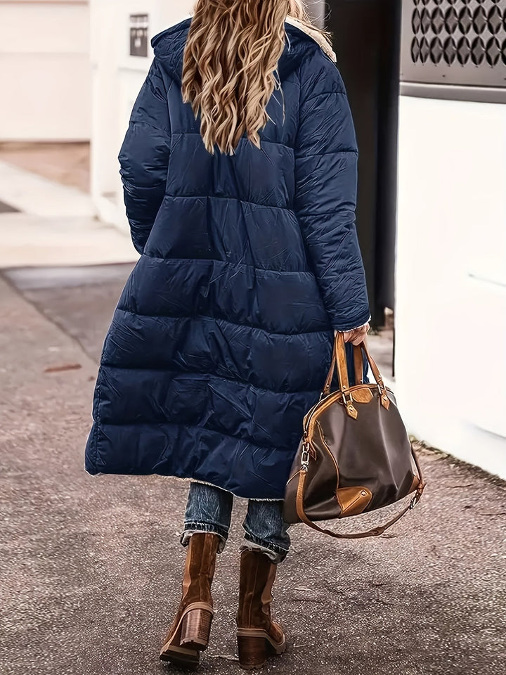 Back view of navy blue maxi puffer coat with hood and quilted panels
