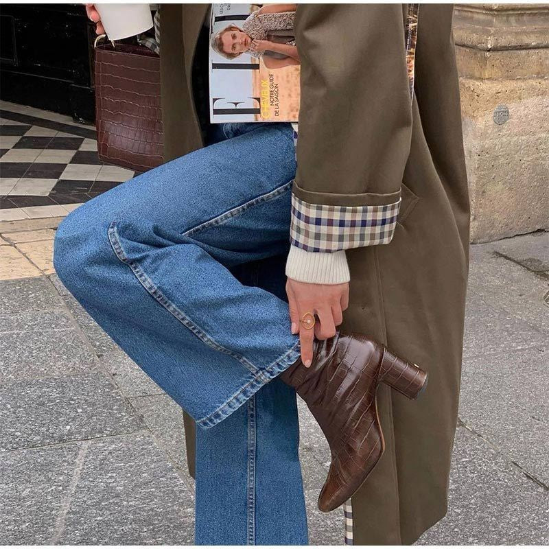 Croc-embossed brown ankle boots paired with khaki trench coat and denim