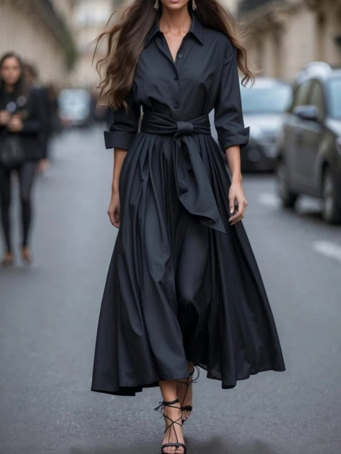 Black collared maxi dress with wraparound tie belt and high-low pleated hem