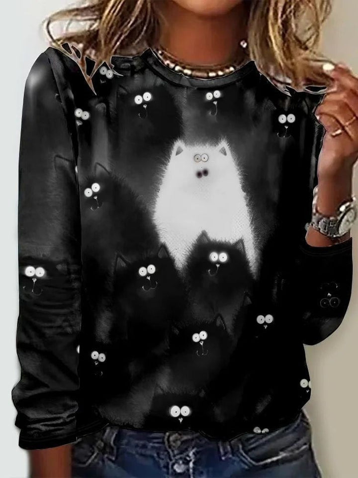 black long-sleeve top with white fluffy cat and cartoon eyes print
