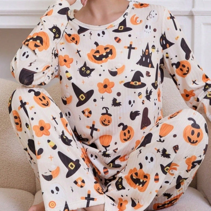 close-up of Halloween pajama set with pumpkin and black cat pattern