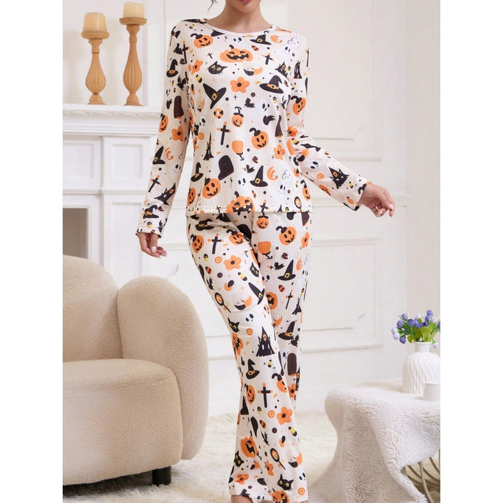 close-up of Halloween pajama top and pants with pumpkin and ghost graphics
