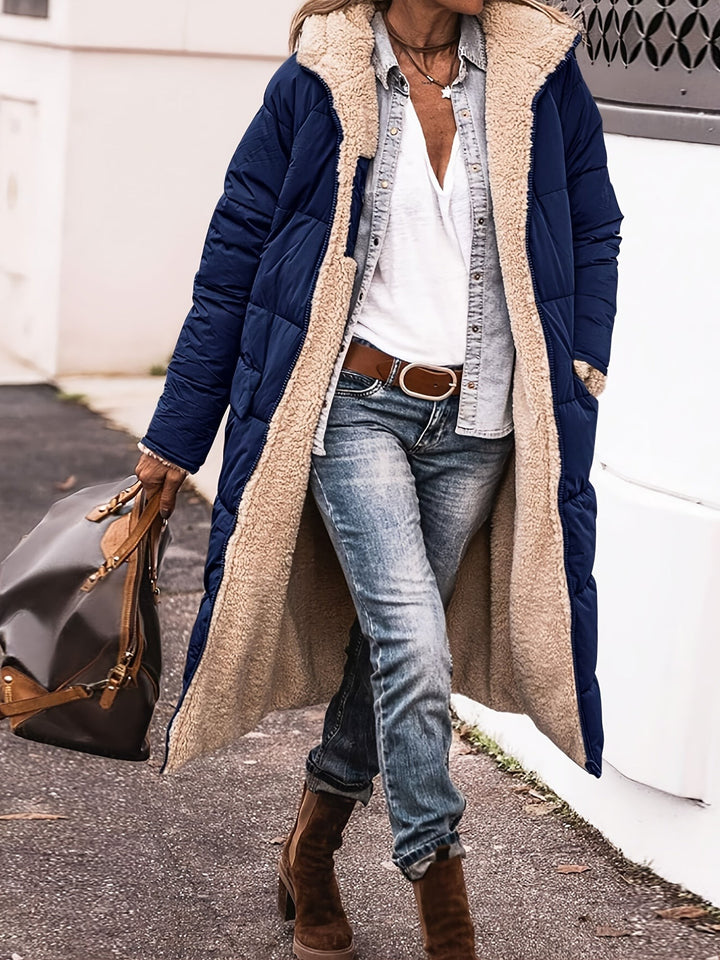 Navy blue long puffer coat with sherpa-lined hood, worn open