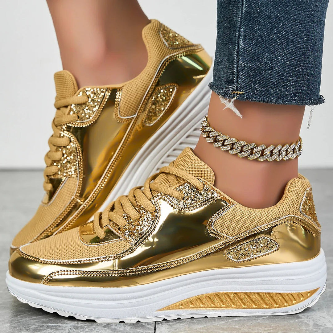 Metallic gold platform sneakers with glitter panels and lace-up chunky sole