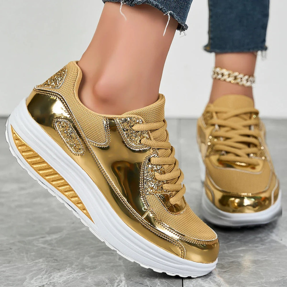 Side view of gold platform sneakers featuring sequin accents and thick white sole
