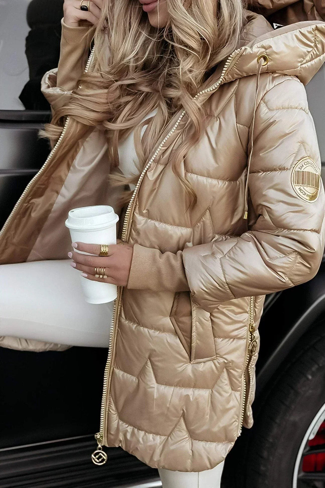gold puffer coat with branded sleeve patch and open front zipper