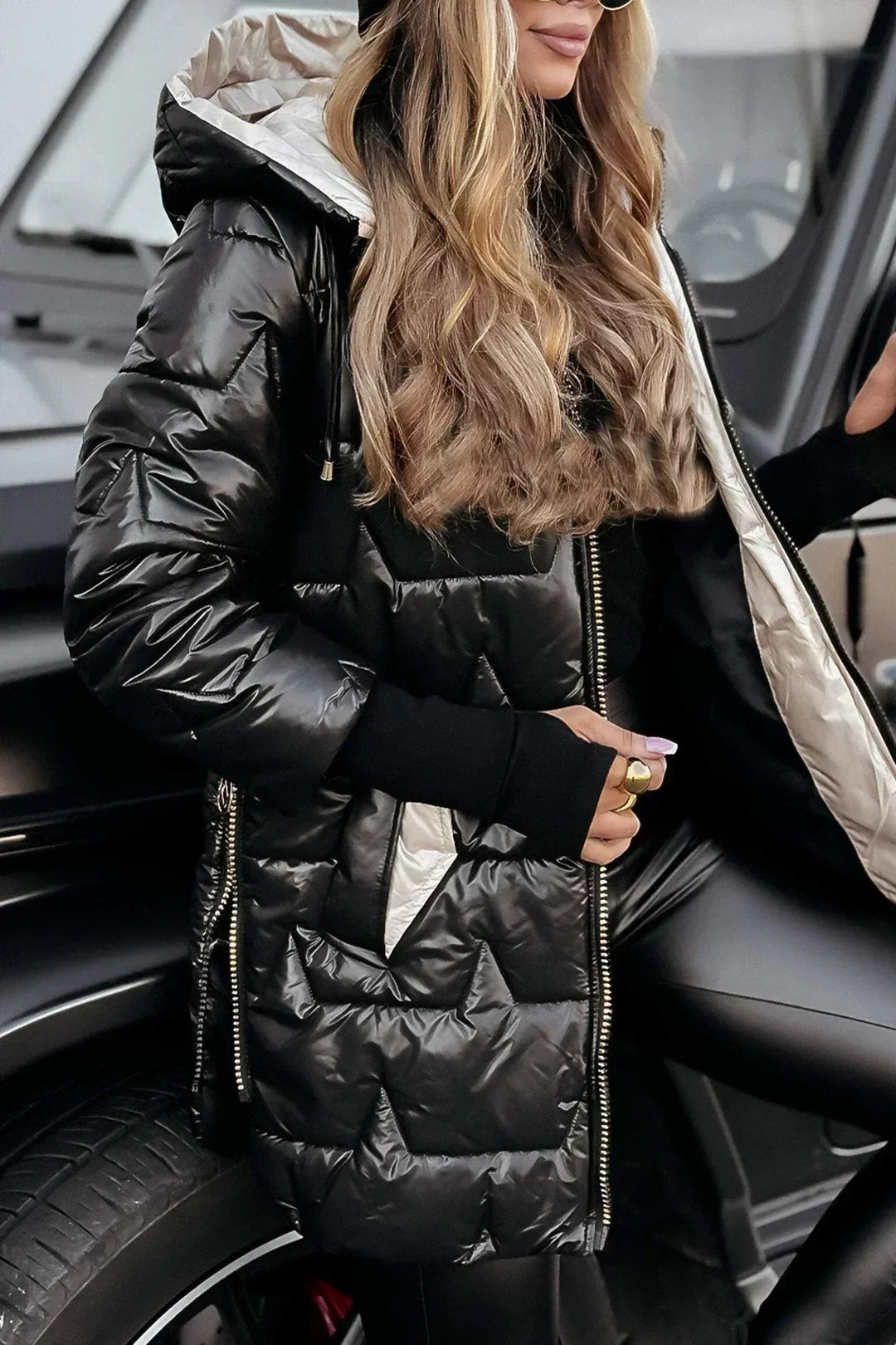 black high-shine puffer coat with contrast beige hood lining, hood up