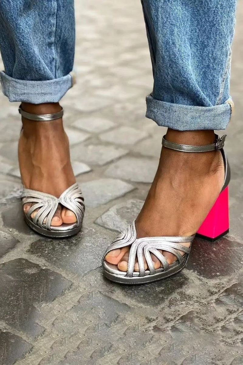 Strappy silver open-toe sandals featuring pink block heel and buckle closure