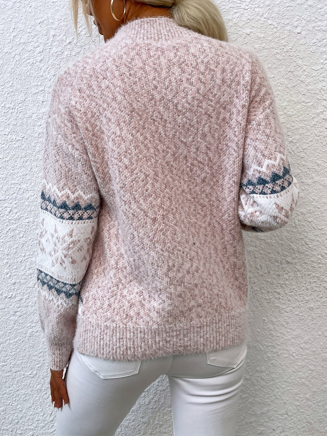 Back view of pink fair isle jumper showing snowflake sleeve detailing
