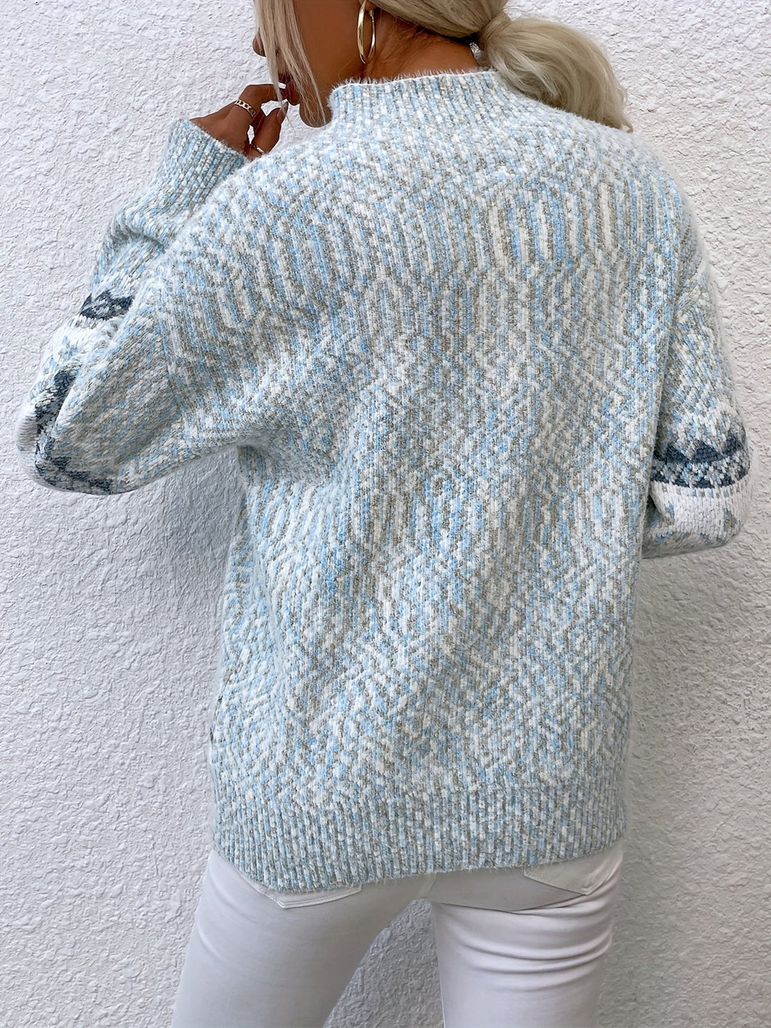 Close-up of pale blue snowflake jumper with mock neckline detail