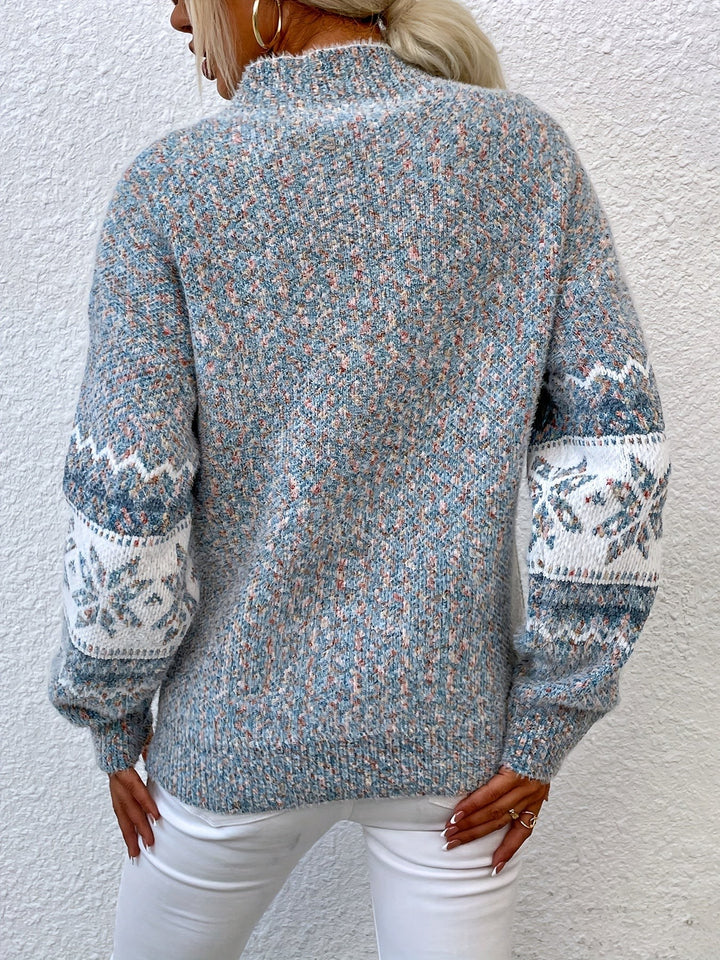 Back view of speckled blue snowflake-patterned knit jumper with fair isle sleeves