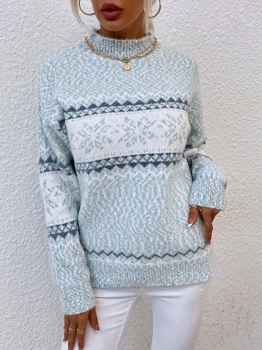 Pale blue knit jumper featuring snowflake band and ribbed cuffs