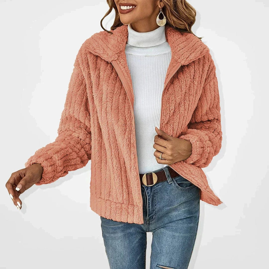 Coral pink fluffy zip-up coat with ribbed texture and relaxed fit
