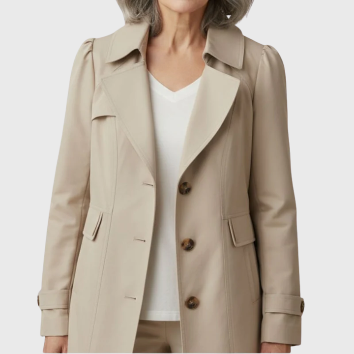 Model wearing tan trench coat with tortoiseshell buttons and tailored collar