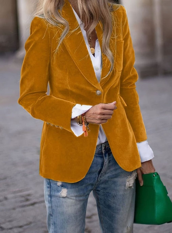 Mustard yellow velvet single-button blazer paired with white shirt and jeans
