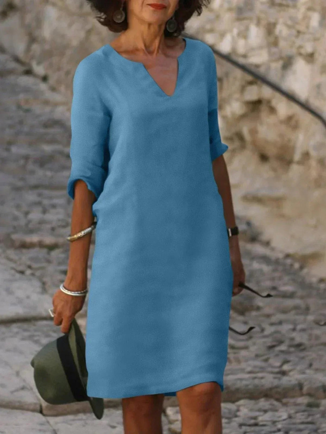 Sky blue V-neck linen dress featuring three-quarter sleeves and shift fit