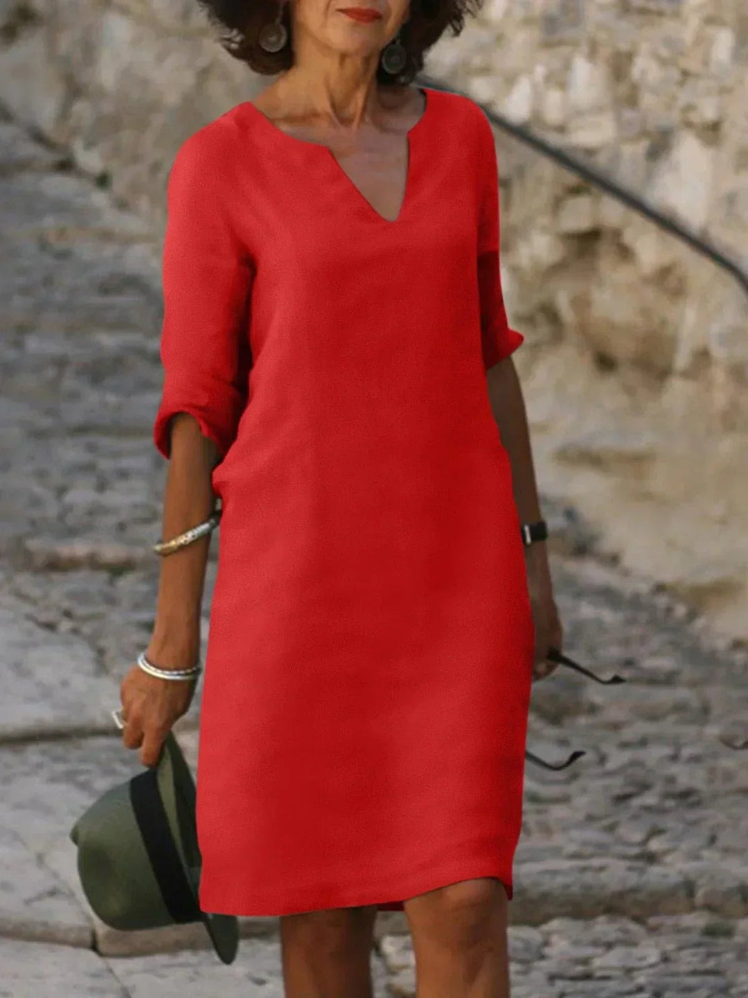 Red V-neck linen dress featuring three-quarter sleeves and shift silhouette