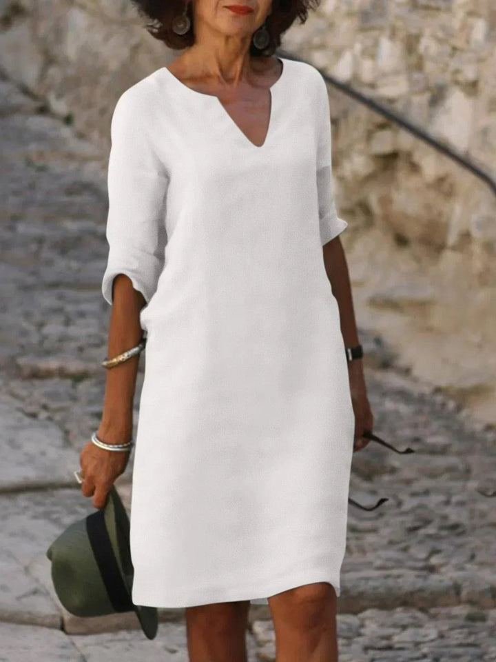 White notch-neck shift dress with half sleeves, minimalist summer style