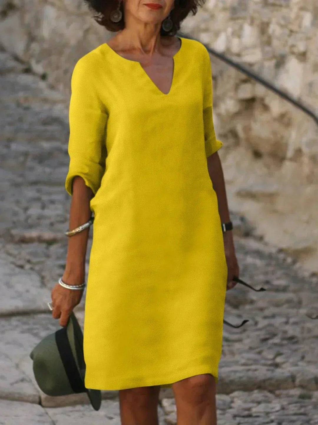 Bright yellow V-neck tunic dress with three-quarter sleeves, knee length