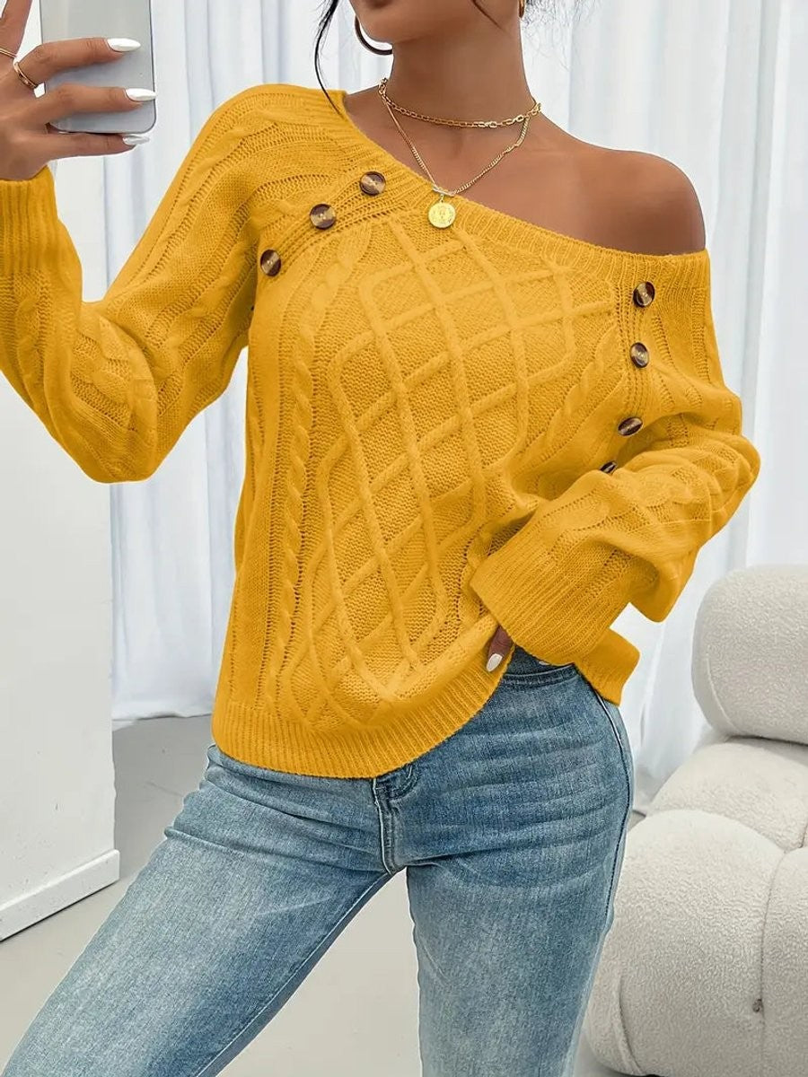Mustard yellow cable knit jumper styled off-shoulder with tortoiseshell buttons