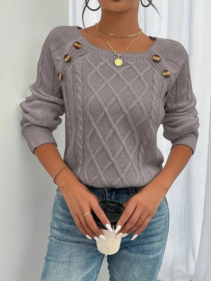 Grey cable knit jumper with button detailing along raglan shoulder seam
