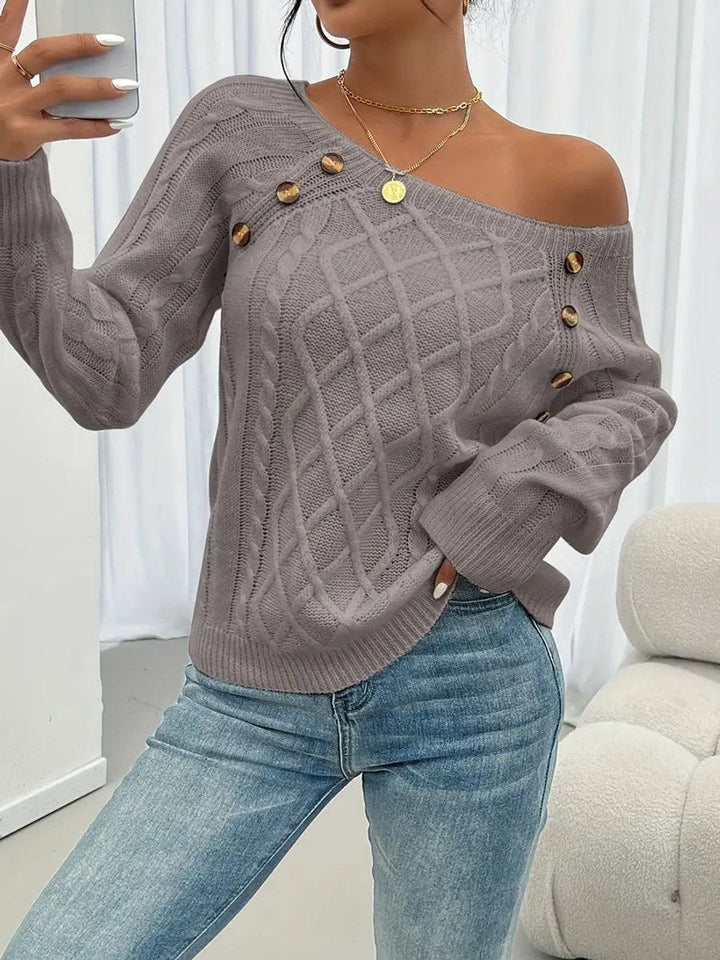 Grey cable knit jumper draped off-shoulder with button-trim accent