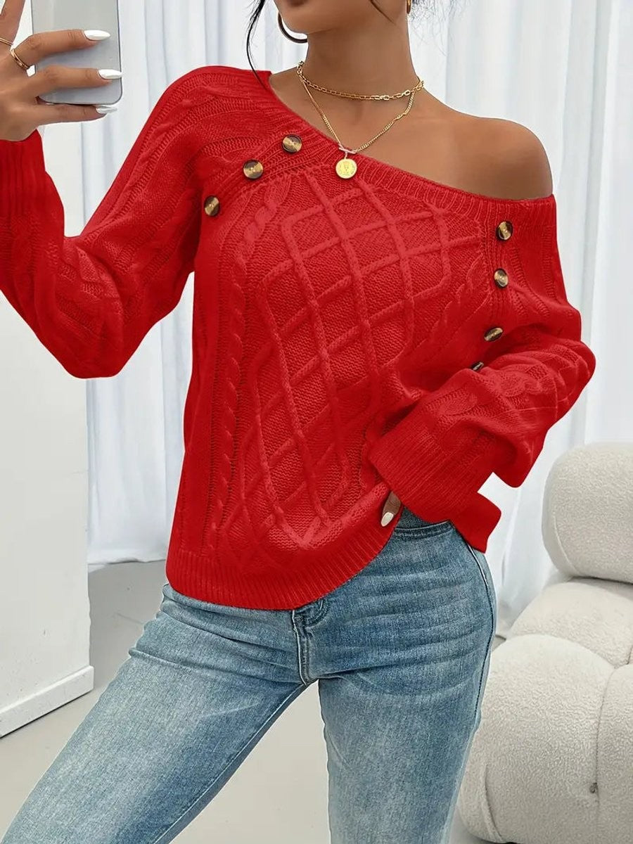 Red cable knit jumper worn off-shoulder with tortoiseshell button trim