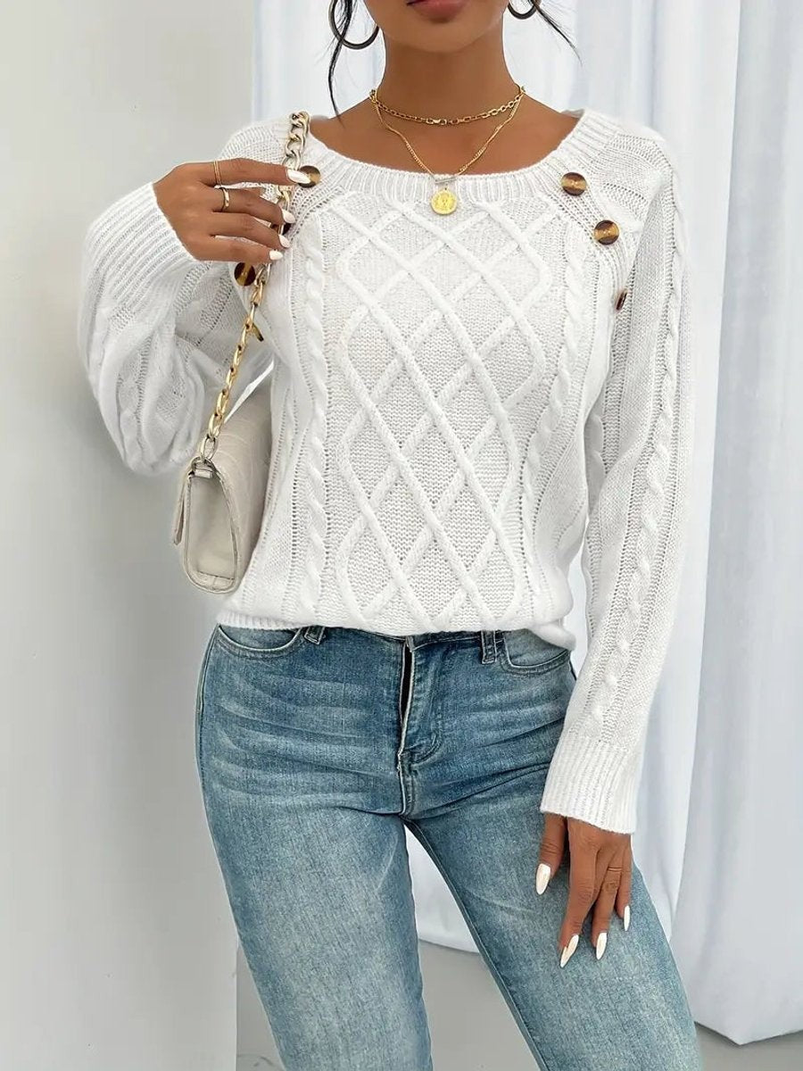 Cream cable knit jumper featuring decorative buttons and long raglan sleeves