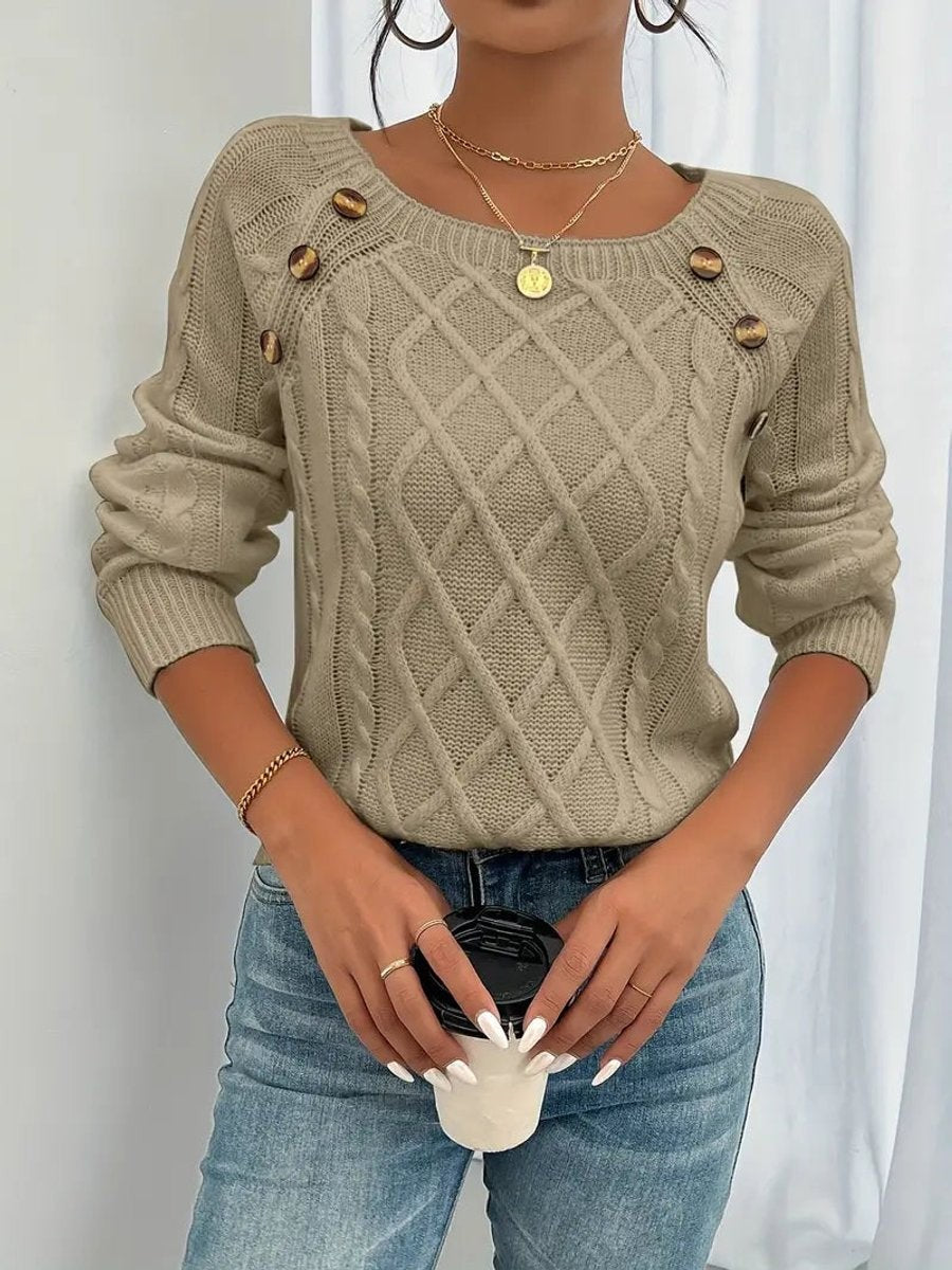 Beige cable knit jumper showing button trim across square neckline