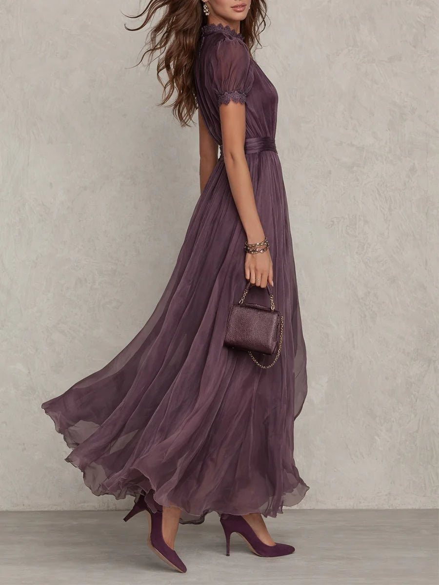 Side view of flowy purple maxi dress with cinched waist and lace cuffs