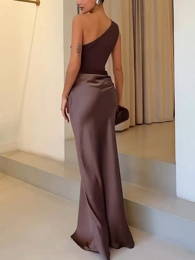 Back view of brown one-shoulder maxi dress showing satin skirt train