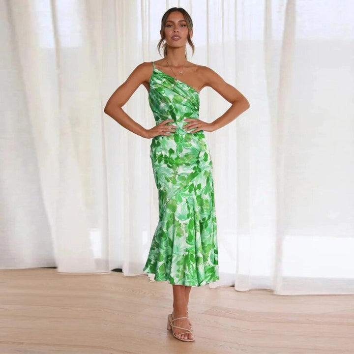 green leaf print asymmetrical dress styled with strappy sandals