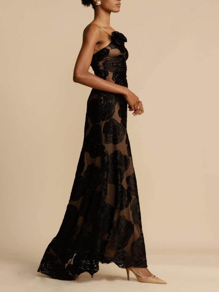 Side view of black rose lace evening gown with sheer skirt and train