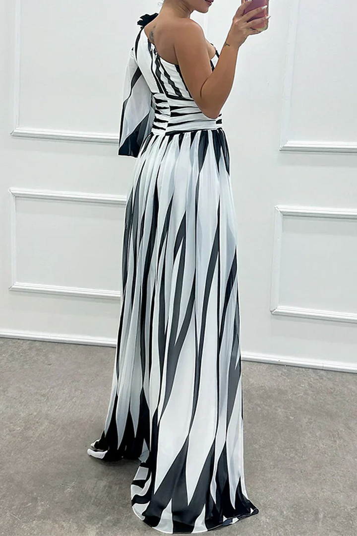 Back view of black and white striped one-shoulder maxi gown