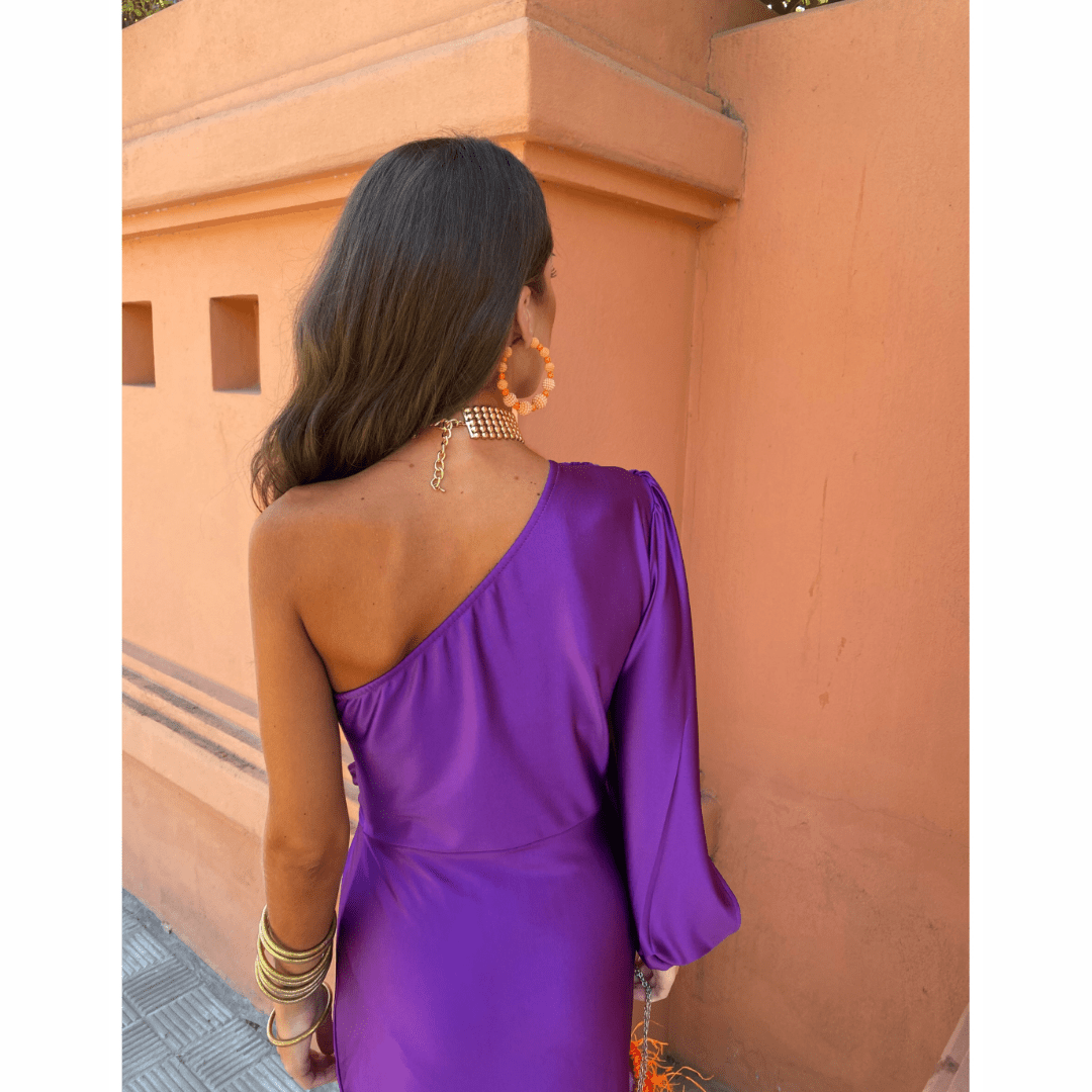 Back view of purple one-shoulder satin dress with sleek draped fit