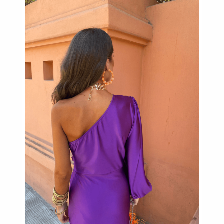 Back view of purple one-shoulder satin dress with sleek draped fit