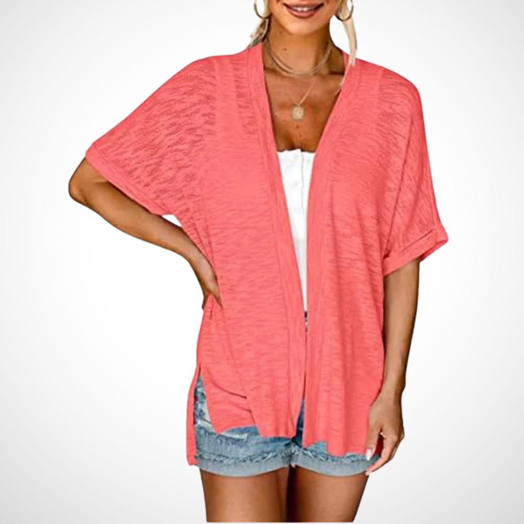 coral open-front short sleeve cardigan worn over white cami top