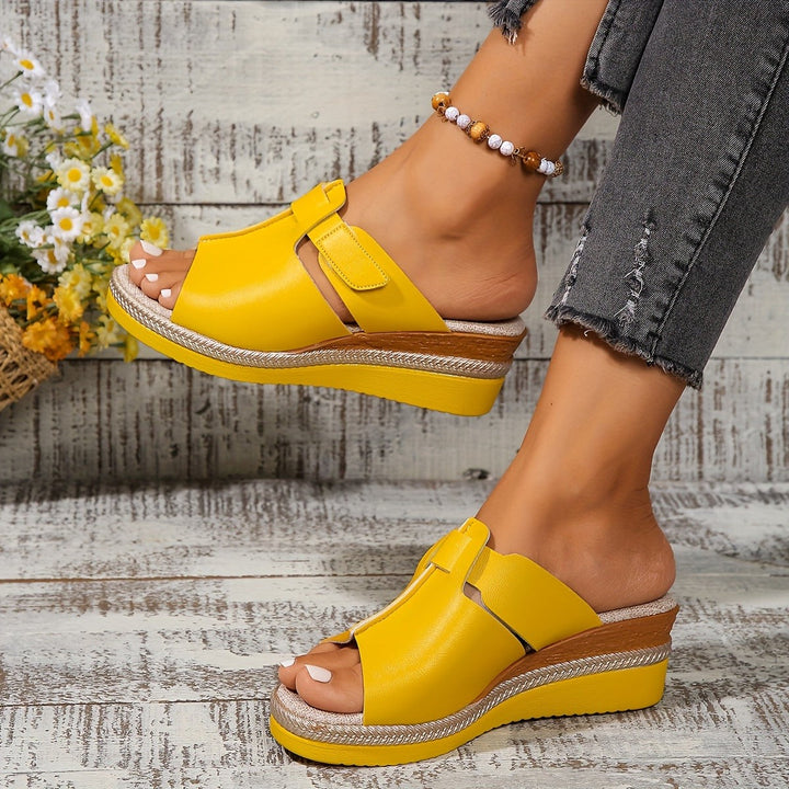 Red peep-toe wedge sandals with woven trim and adjustable ankle strap