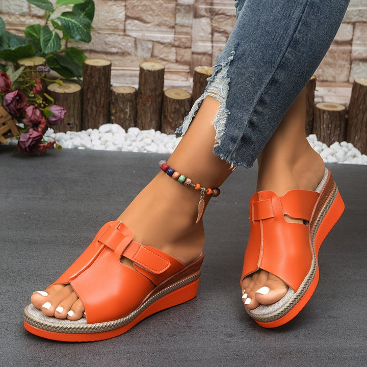 Hot pink wedge sandals with braided platform and T-strap design