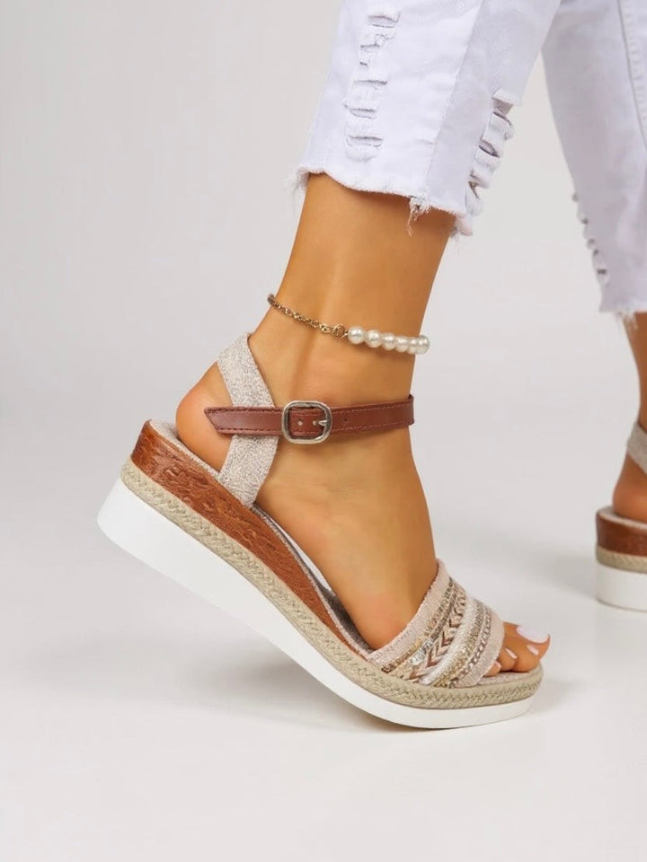 Close-up of tan buckle strap on beaded espadrille wedge sandal