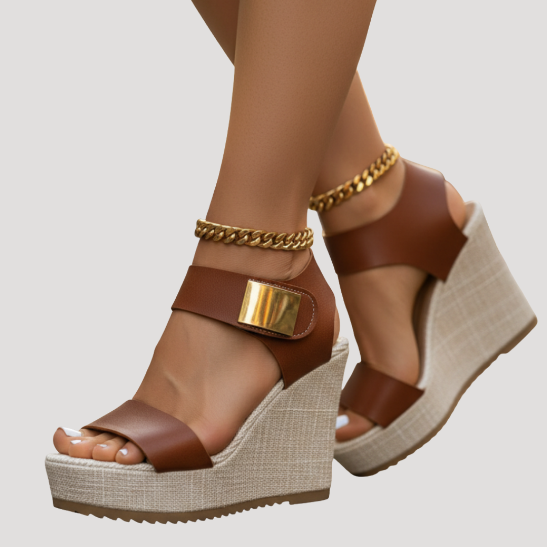 Cognac platform wedge sandals featuring gold hardware and chunky ankle chain